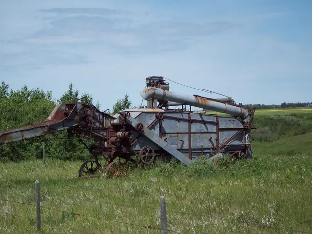 Old threshing machine in a field
